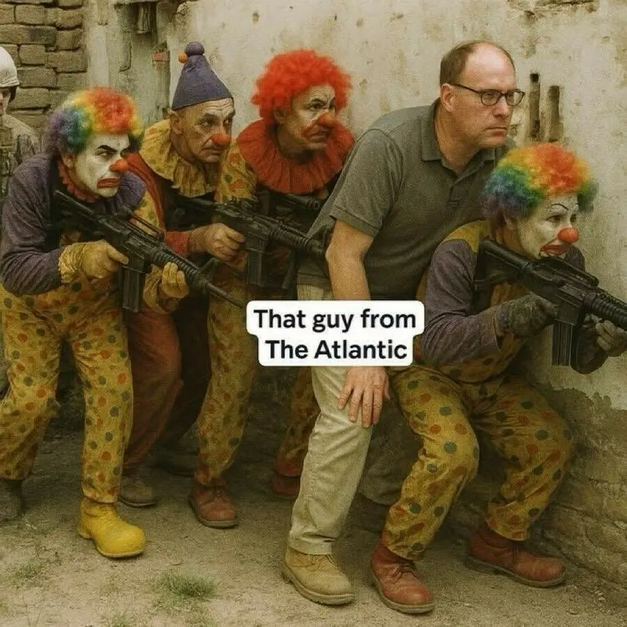 Clowns in full make-up and wigs crouching behind a wall while holding assault rifles. A guy with glasses in chinos and a t-shirt is standing with him. The caption next to him reads 'That guy from the Atlantic'