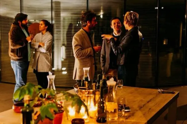 five people standing while talking each other