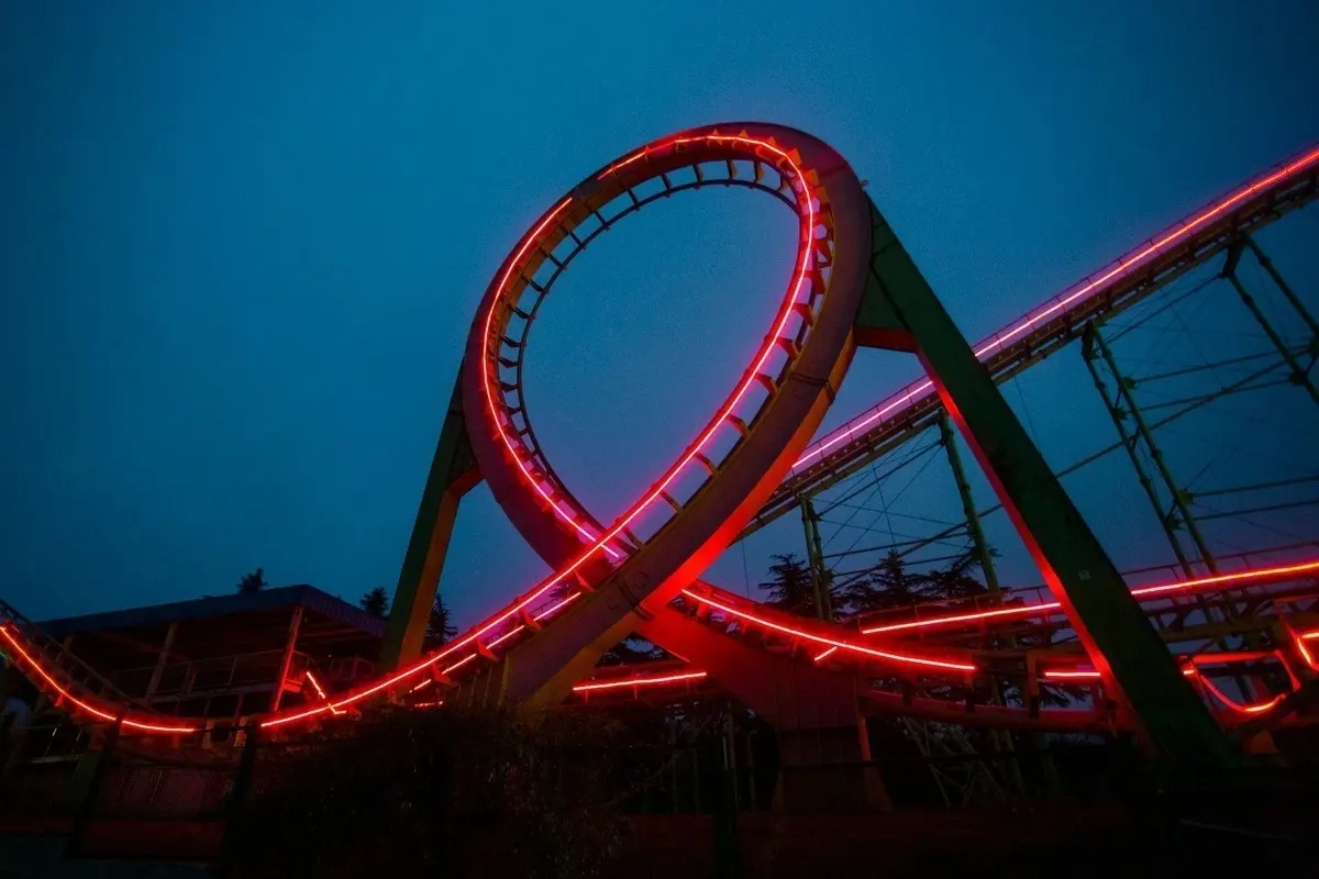A roller coaster lit up at night with red lights