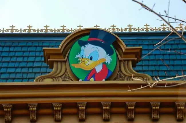 Auto-generated description: A cartoon character with a top hat is depicted on a decorative rooftop emblem.