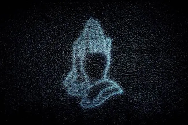 Neon sign of praying hands seen through a fibreglass window