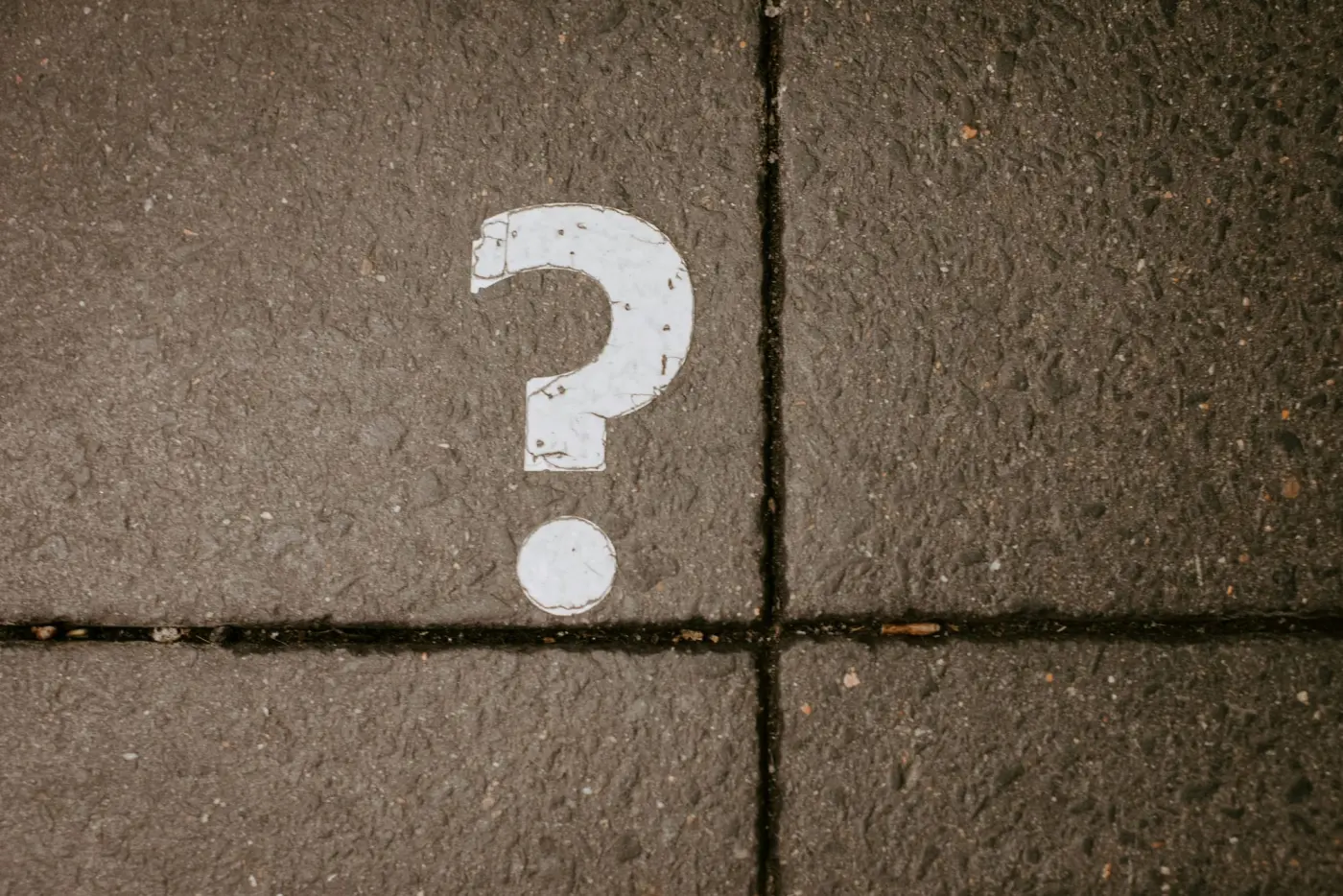 A question mark painted on concrete