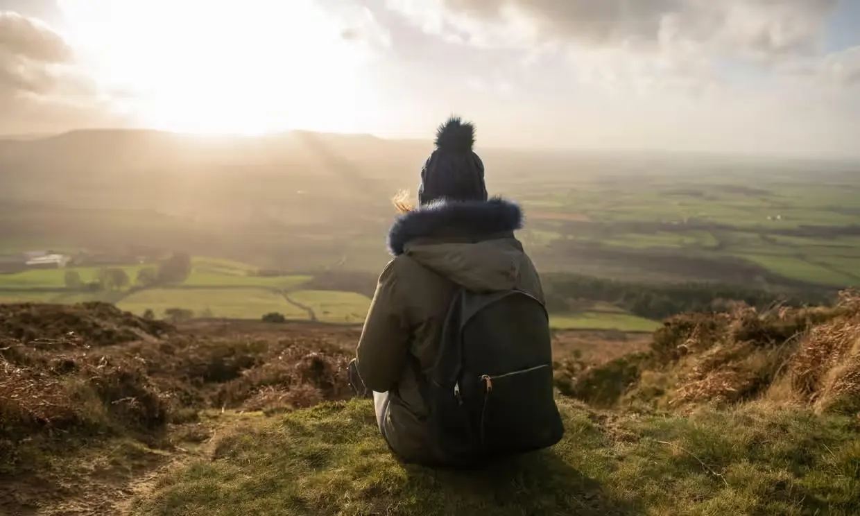 Person sitting on a hillside