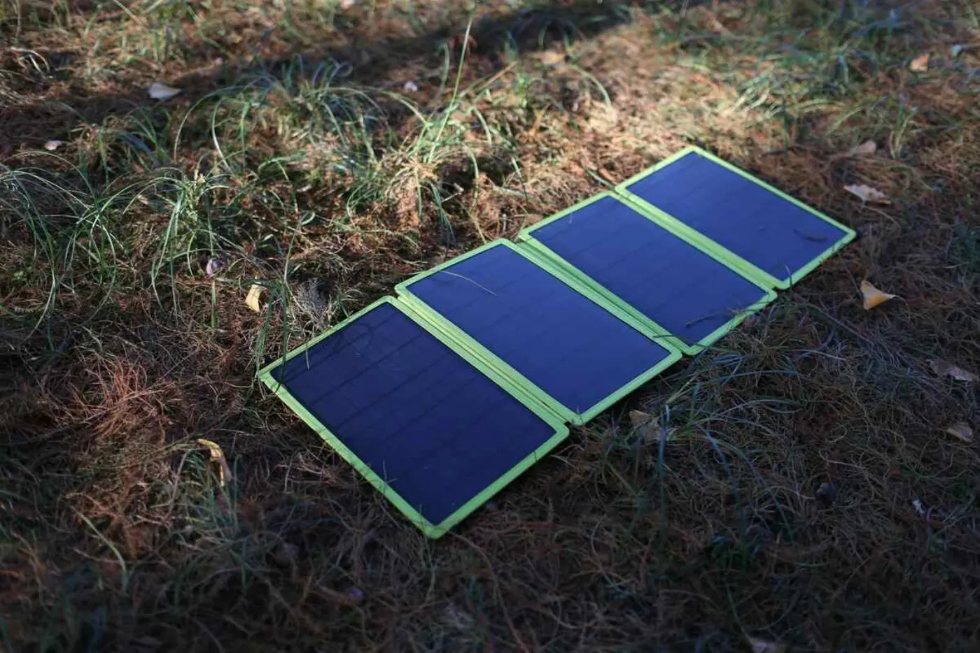 A portable solar panel array, unfolded on the ground