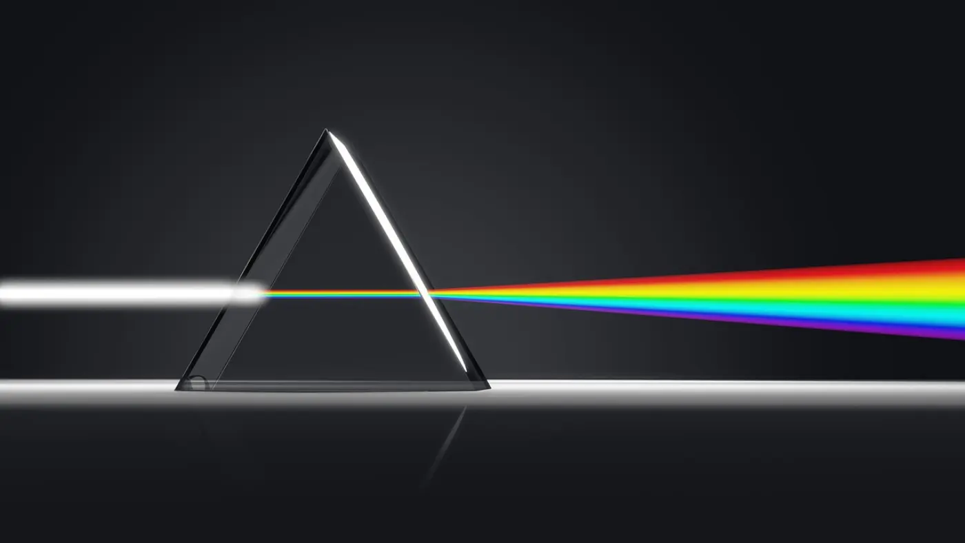 White light going through a prism and being refracted into the colours of the rainbow. Image from Pixabay.