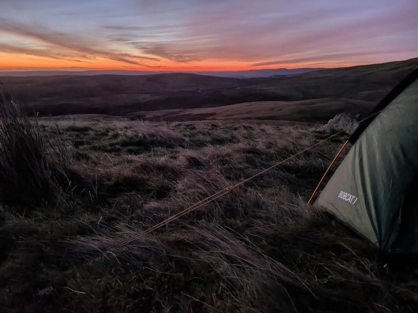 Sunrise over the Northumbrian hill with part of a tent in the foreground