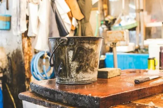 gray bucket on wooden table