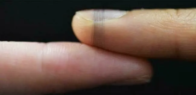 Two fingers with the very fine electronic spider silk wrapped around