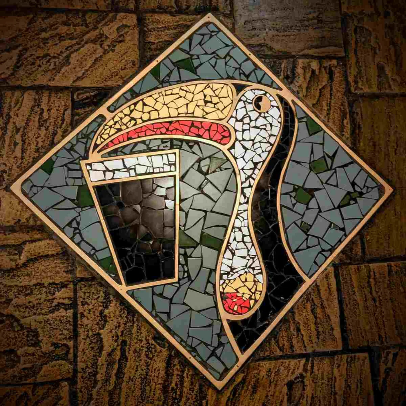 A mosaic of a toucan drinking Guinness