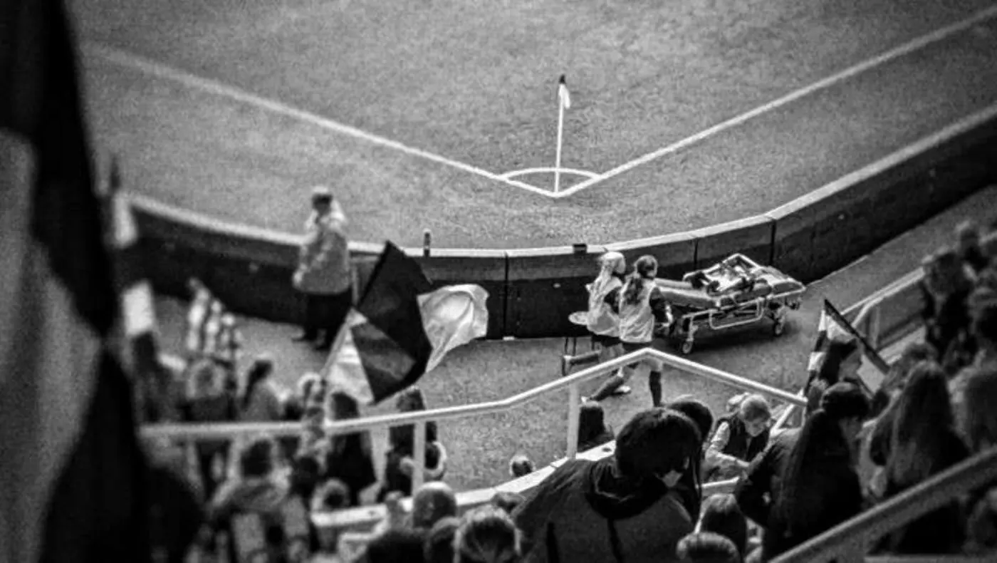 Two ball girls (one is Doug's daughter) running around the edge of the pitch at St James Park.